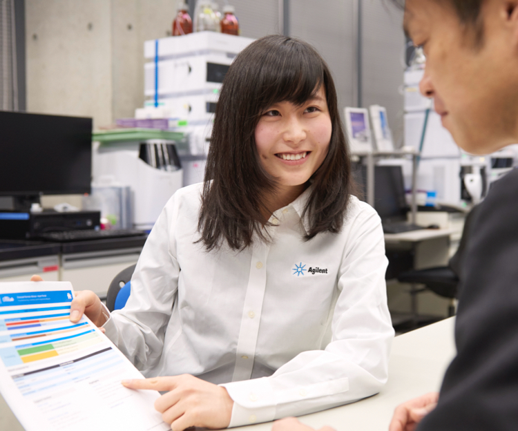 A woman pointing out details of a document to a male colleague