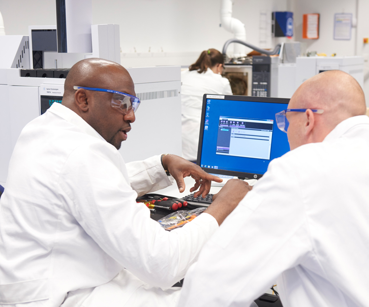 A group gathered around a computer screen