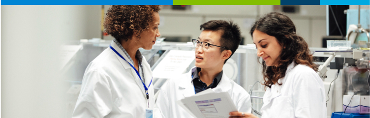 A group of young laboratory technicians in discussion